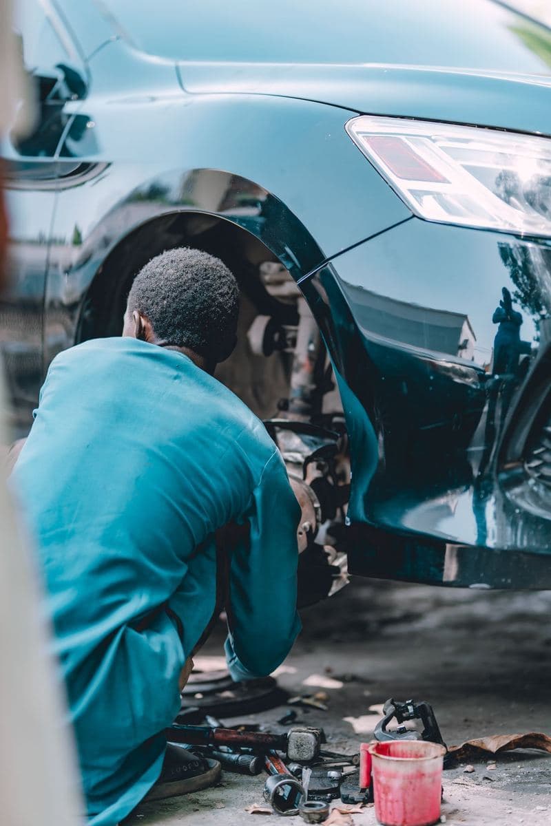 A mechanic fixing a car's brakes