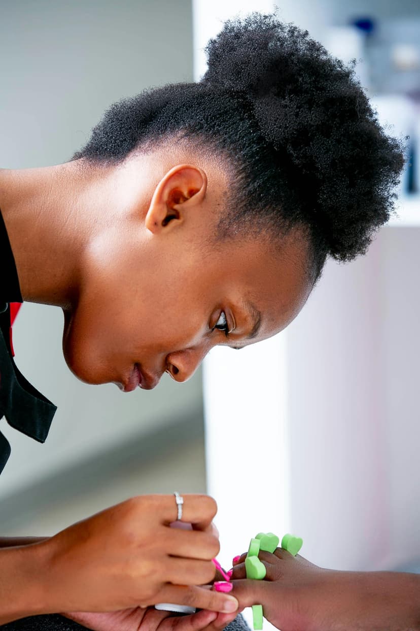 Nail technician working on a client